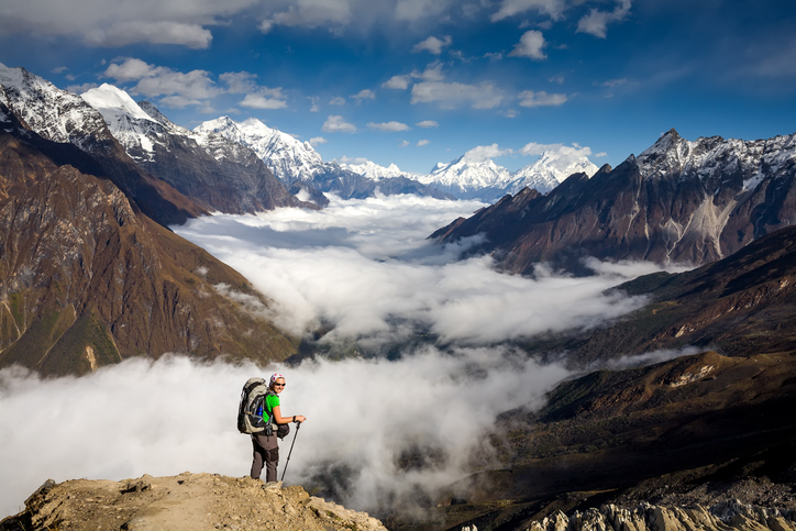 Hiker on a mountain trail in Nepal covered by adventure sports travel insurance