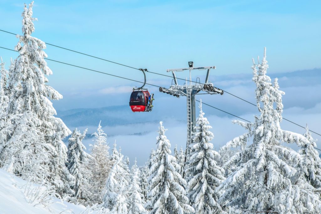 Cable car leading up to the slopes — winter sports insurance for over 65s.”